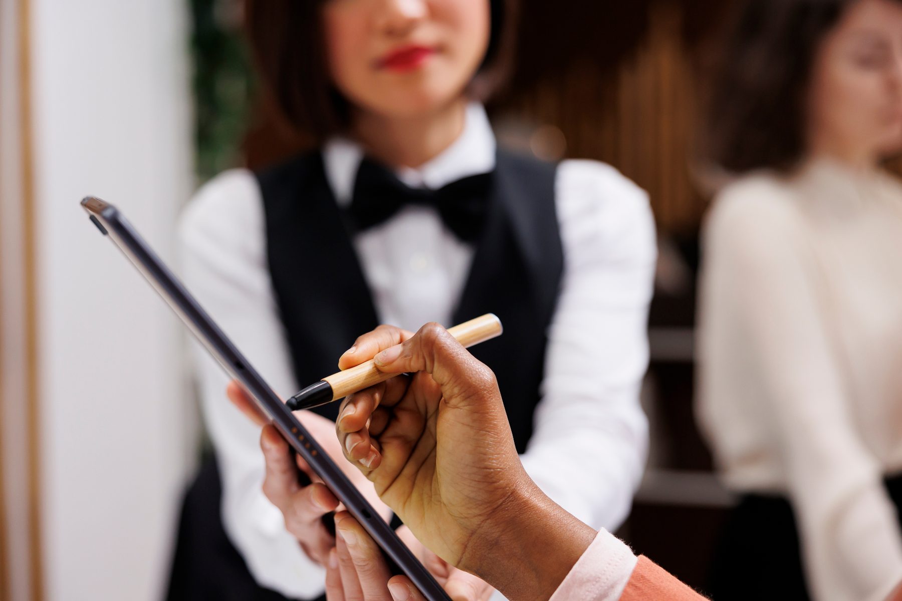 Banquet server taking a service order on a tablet during an event