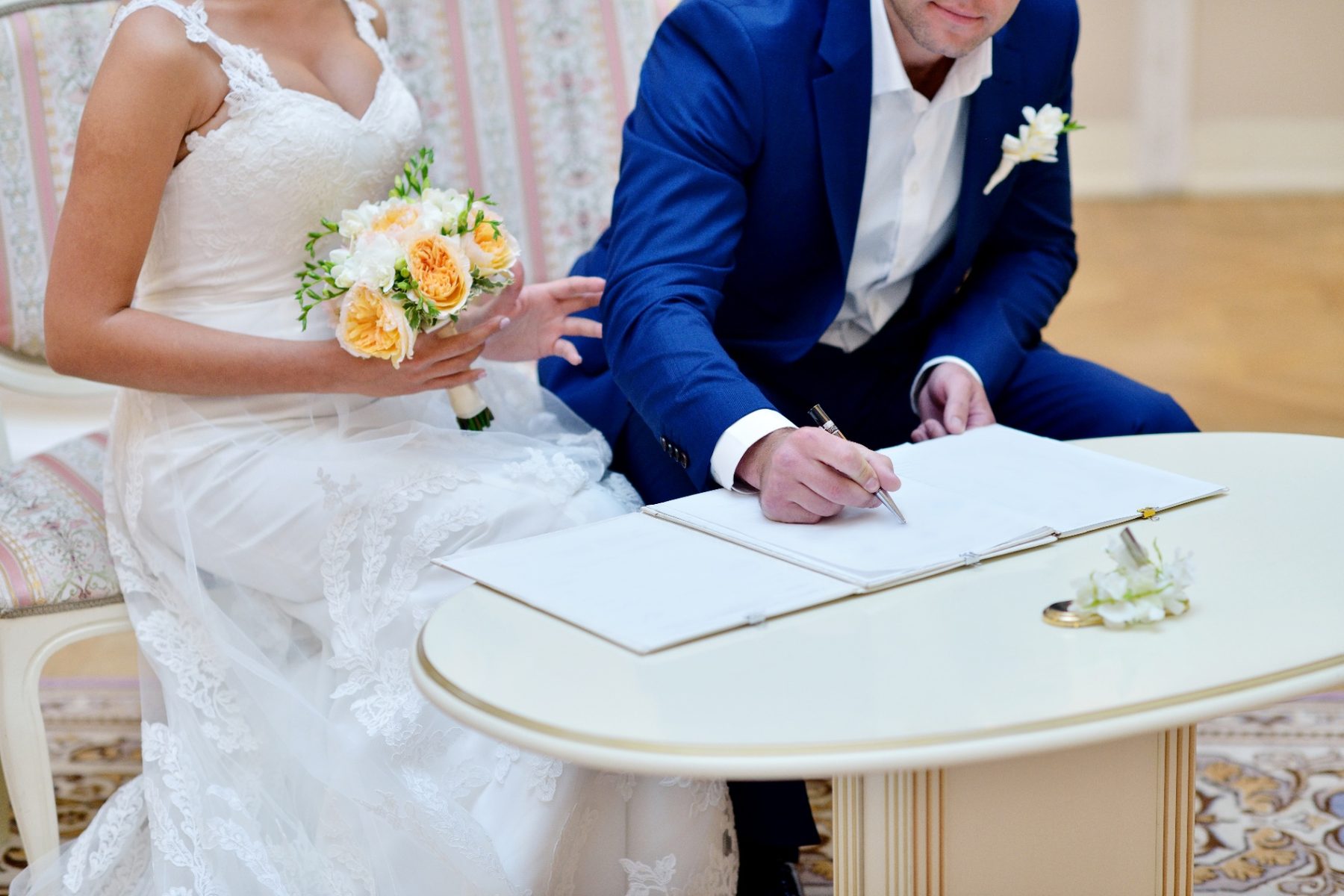Bride and groom signing their wedding venue contract together